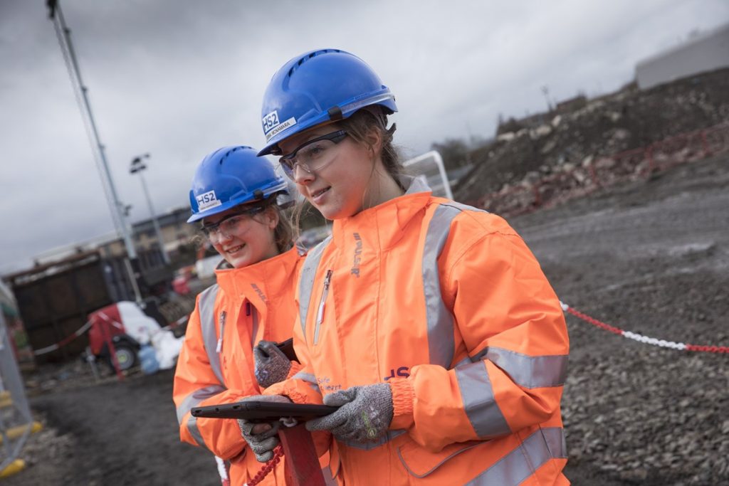 Graduate railway engineers in orange PPE
