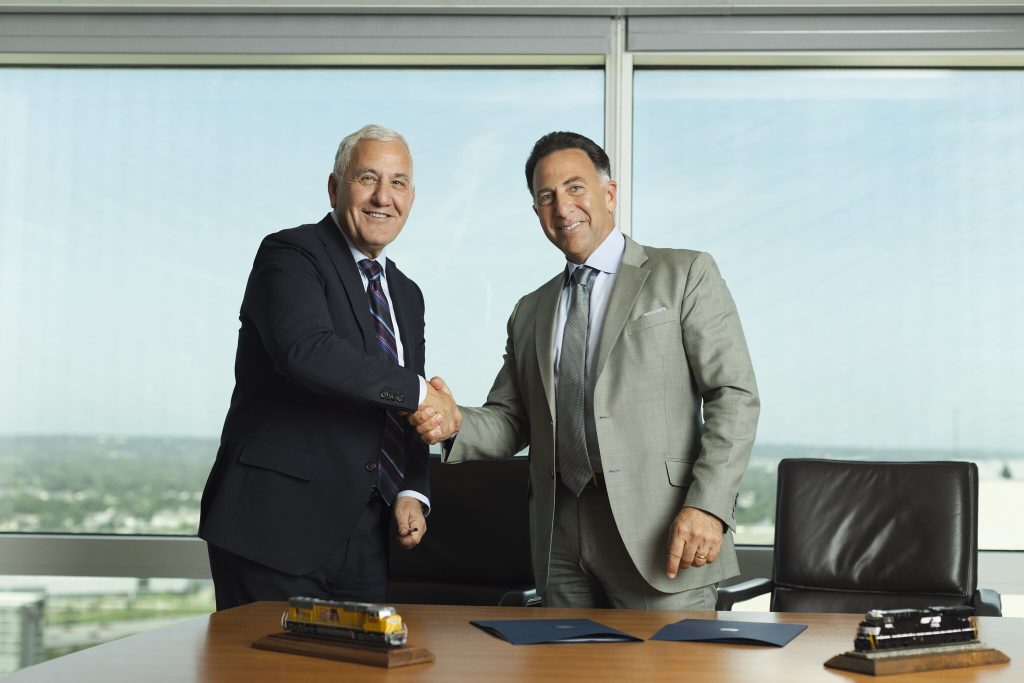 UP's CEO Jim Vena and NS CEO Mark George celebrating the merger agreement a few days ago. Image: © Union Pacific